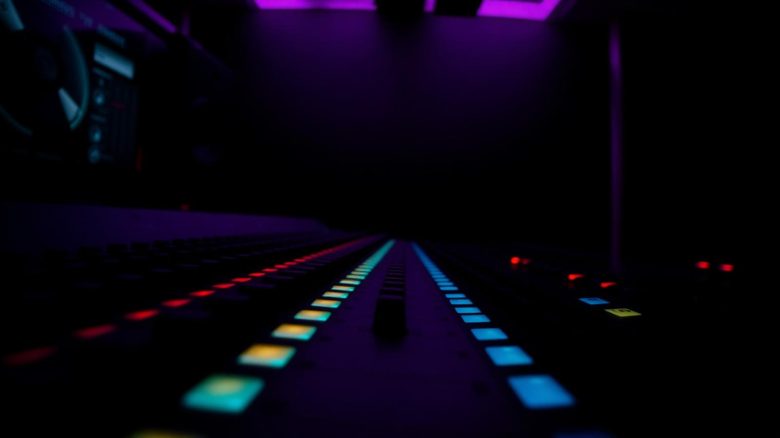 Mixing console glowing in studio lights